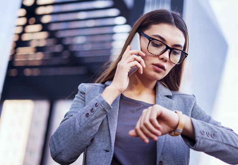 A woman on the phone because she's late for her interview