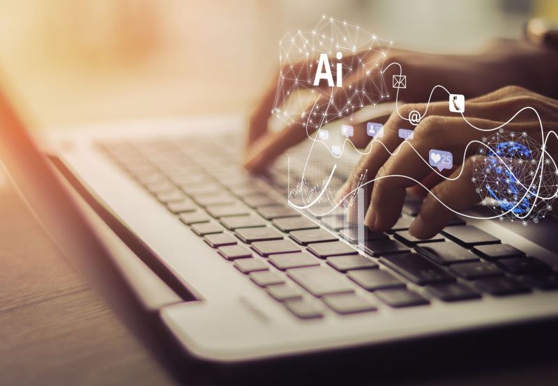 Person’s hands typing on laptop keyboard searching Emerging recruitment technologies 2025, Future of hiring and workforce management and AI in recruitment and hiring 