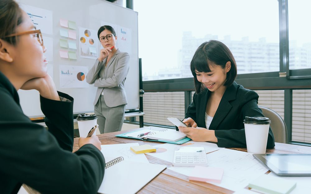 A woman looking at her phone during a job interview 