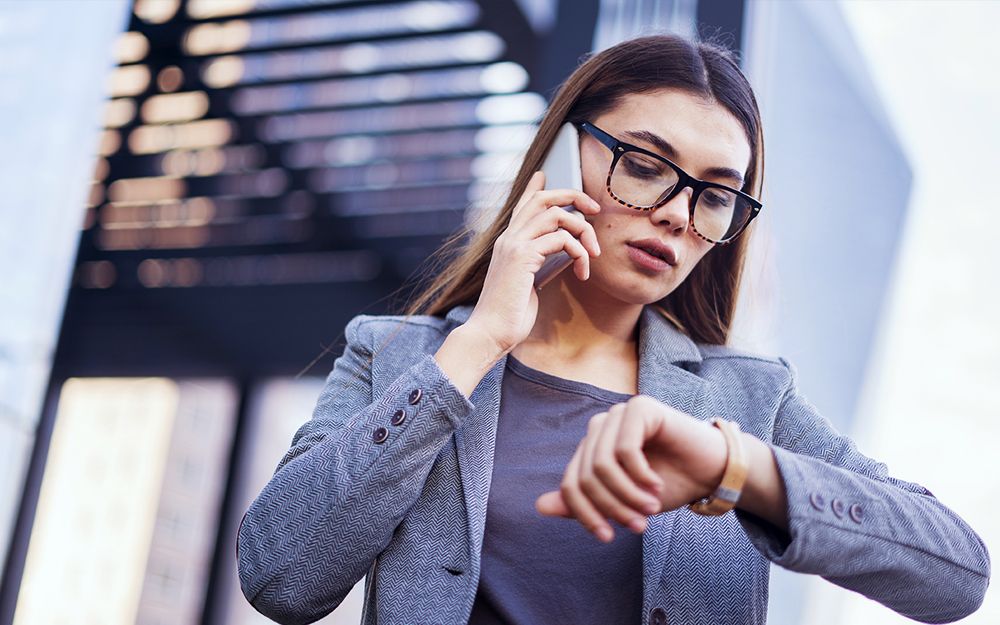 A woman on the phone because she's late for her interview