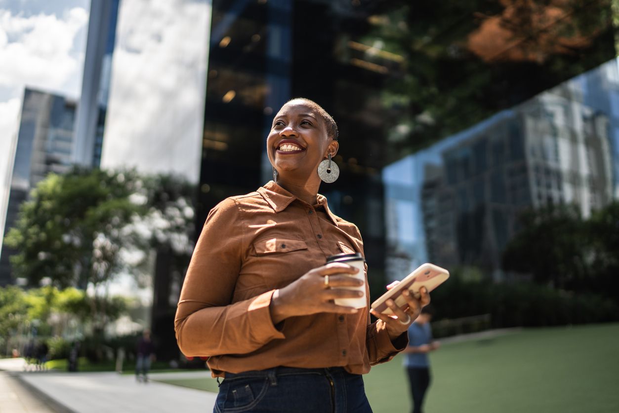Happy woman with a coffee in hand